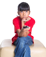 Young Asian girl with television remote control device 