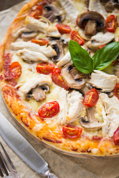 Pizza with chicken and mushrooms close up
