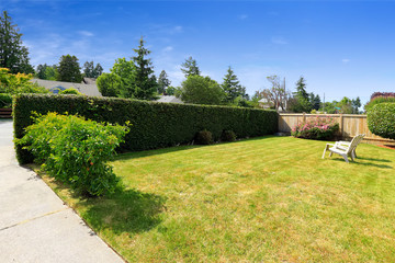 Front yard with sitting area and trimmed hedges