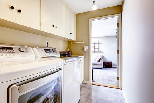 Small laundry area with cabinets