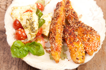 chicken breast with breadcrumbs and sezame seeds