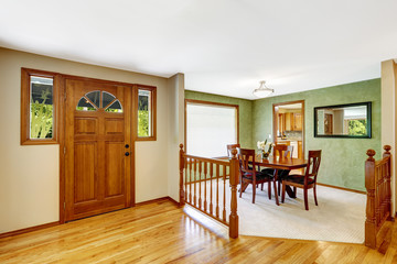 House interior. Entance hallway with balustrade and green dining