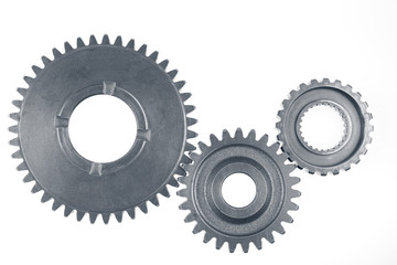 Three steel cog gears isolated on white