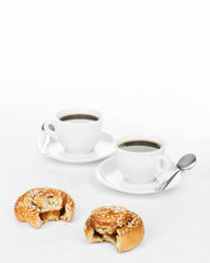 Two partially eaten cinnamon buns.