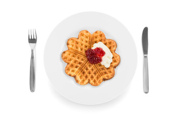 Waffles, cream and jam served on a white plate.