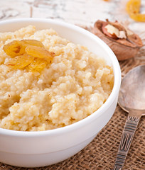 Porridge in a bowl with nuts and raisins