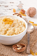 Porridge in a bowl with nuts and raisins