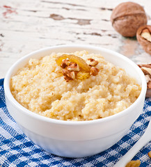 Porridge in a bowl with nuts and raisins