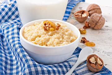 Porridge in a bowl with nuts and raisins