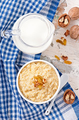 Porridge in a bowl with nuts and raisins