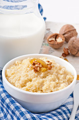 Porridge in a bowl with nuts and raisins
