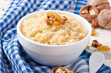 Porridge in a bowl with nuts and raisins