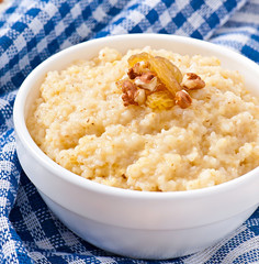 Porridge in a bowl with nuts and raisins