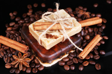 Organic soap with coffee beans and spices, on dark background