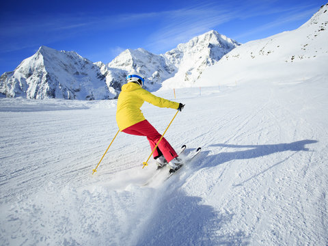 Skiing, skier, winter sport - woman skiing downhill