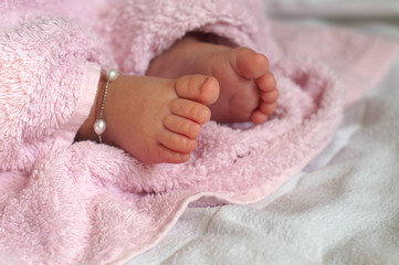 Close-up of  Baby feet under blanket