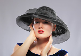 woman in wide black mesh hat