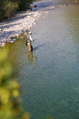 Upper view of fly fisherman fly-fishing in river