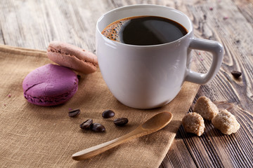 Cup of coffee and french macaron.