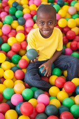 Fototapeta na wymiar Cute boy smiling in ball pool
