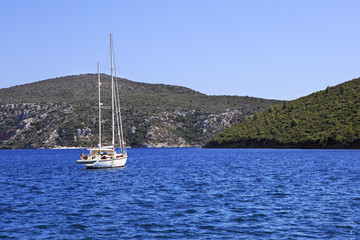 Fototapeta na wymiar Two yachts in the bay of Aegean Sea.