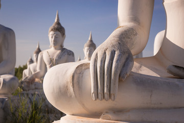 Hand white buddha status on blue sky background