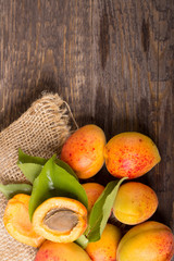 Naklejka na ściany i meble Apricots with sack cloth on wooden table 