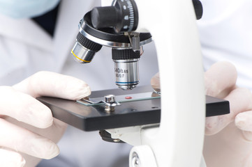 Closeup on clinician studying chemical element in laboratory.