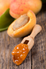Handmade apricot jam with fresh fruits on wooden table 