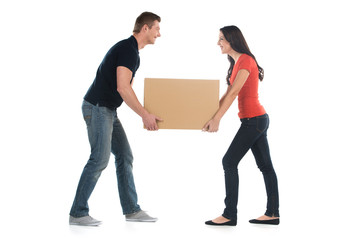 Beautiful young couple holding big heavy box.