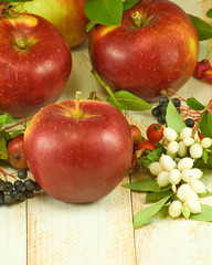 apples and berries on a wooden table closeup