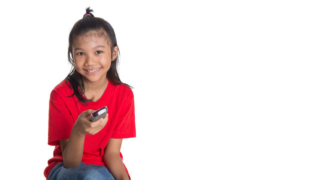 Young Asian girl with television remote control device