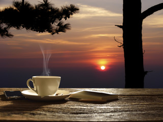 Morning cup of coffee with sunrise background - obrazy, fototapety, plakaty