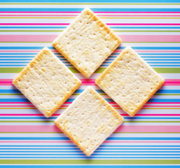 Yellow biscuits on striped background