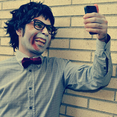 hipster zombie taking a selfie, with a retro effect