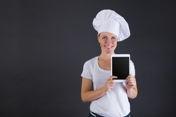 woman chef with tablet over dark background