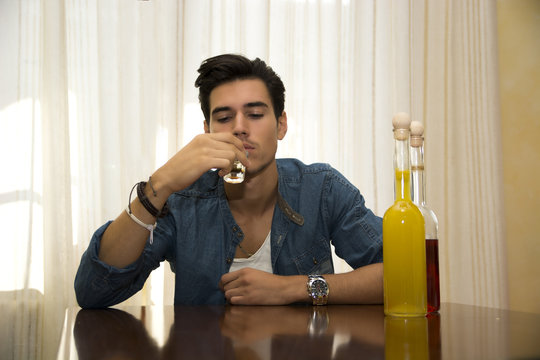 Young Man Sitting Drinking Alone