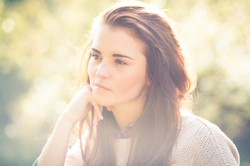 Young woman outdoor portrait, soft sunny daylight