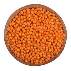 Seabuckthorn in a wooden bowl on a white