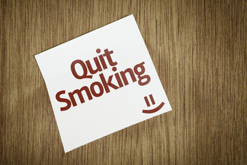 Quit Smoking on Paper Note on sky background