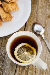 Cup of tea with lemon and cookies