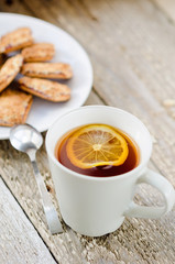 Cup of tea with lemon and cookies