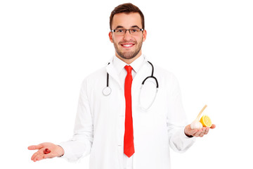 Doctor showing pills and garlic with lemon