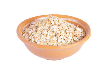 The oat flakes in a ceramic plate