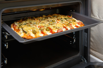 Baking pizza in oven.