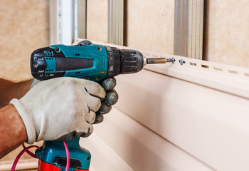 man screws in a wall