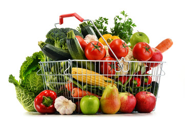 Wire shopping basket with groceries isolated on white