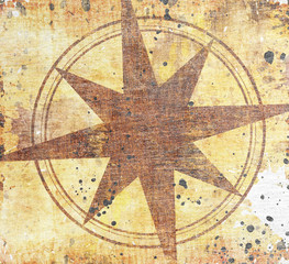 Old compass on paper background