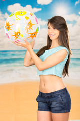 beautiful young girl playing with beach ball