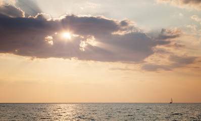 Boat sailing on the sea at sunset